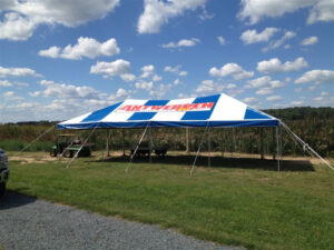 Blue and white 20x40 event tent with a logo on the top