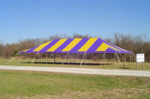 Yellow and purple event tent set up in a field