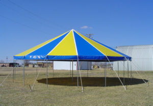 Yellow and blue circle pole tent set up in front of Miami Missionary Tent Co