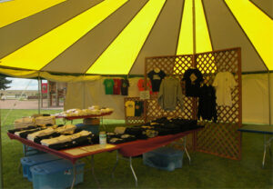 Yellow and white event tent set up as a shop