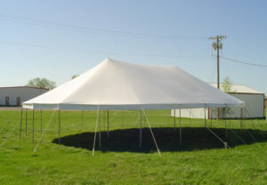 All white pole tent set up in a field