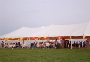 All white pole tent set up for an event