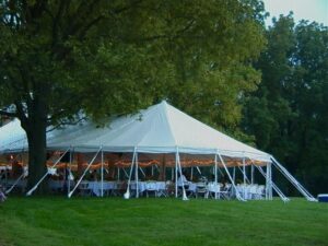 One of our all white pole tents set up for an outdoor wedding