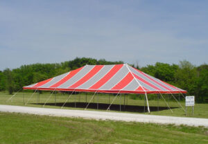 Red and grey event tent set up in a field