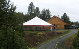 white event tent set up by a house
