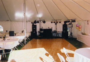 A stage under an all white event tent