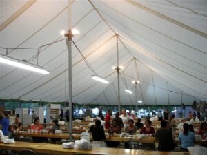 All white event tent set up with tables underneath