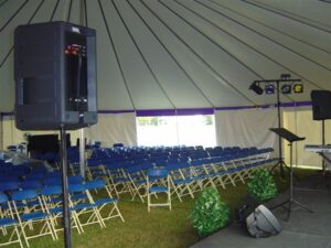 An all white pole tent set up for a revival