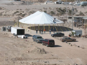 All white pole tent set up in a dessert