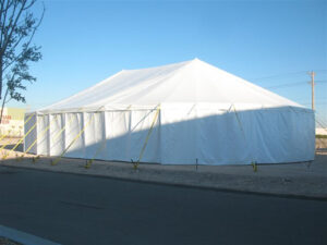 All white event tent in an empty lot