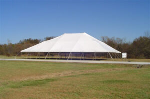 A white pole tent set up at Miami Missionary Tent Co