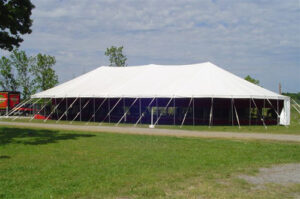 All white pole tent set up in a field