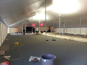 Construction of a large all white pole tent