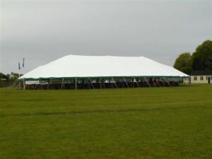 Large white pole tent with a green valance