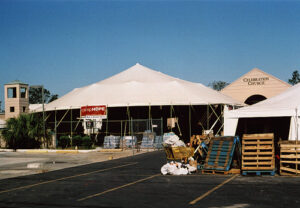 A large white pole tent set up outside of a church