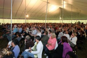 Large revival tent with people underneath