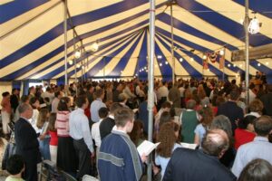 Group of people under a revival tent