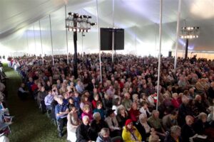 Under a revival tent filled with people