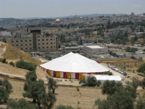 Large white tent with red, yellow and white sidewall