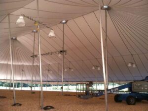 Very large all white pole tent being set up for an event