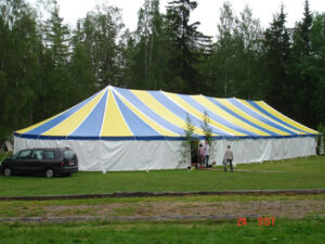 Yellow and blue pole tent set up for an outdoor event